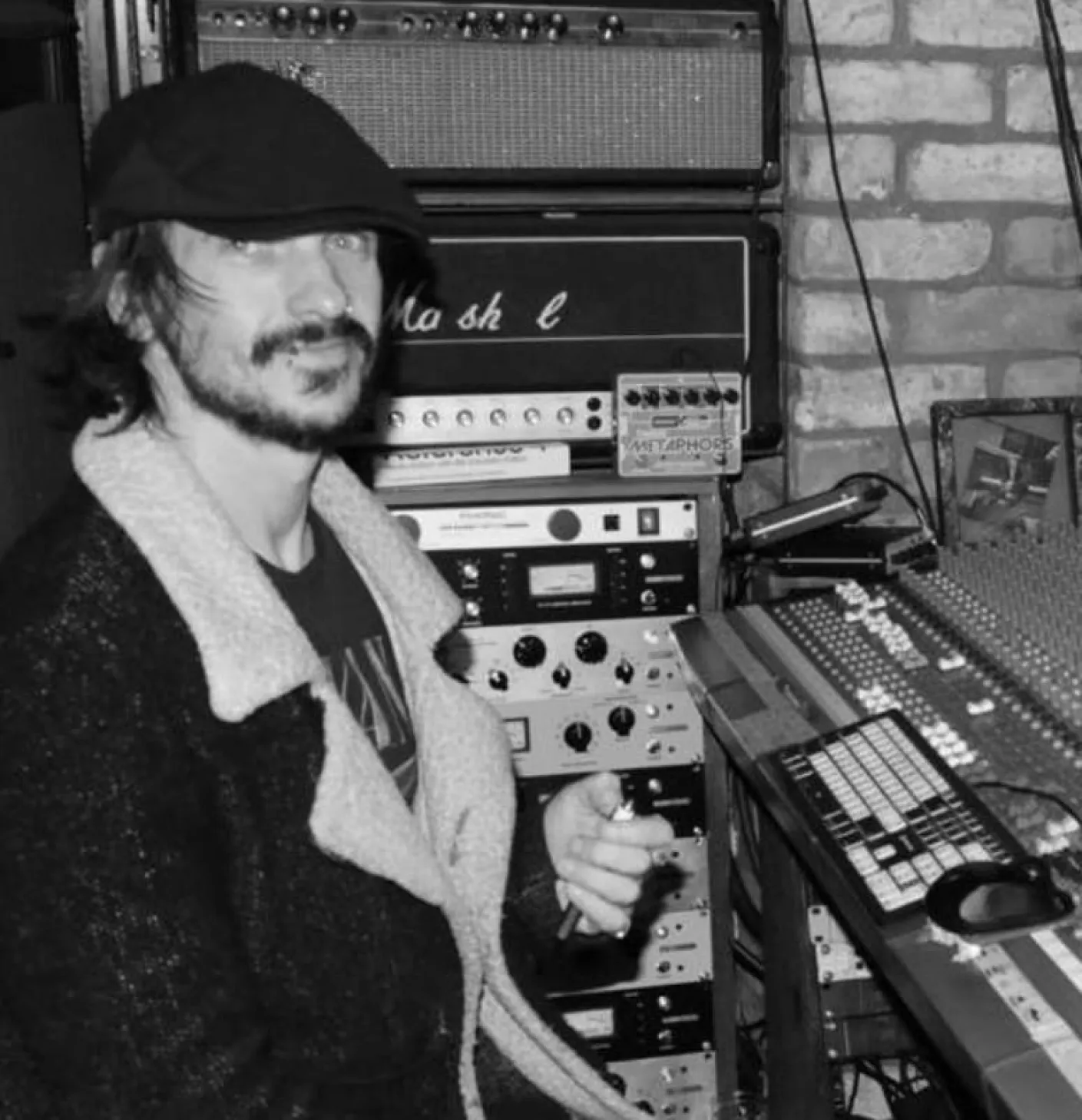 Man leaning over mixing desk